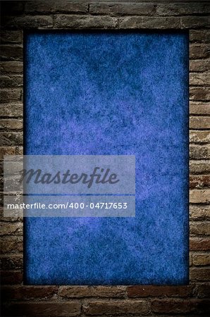 Grunge blue paper in a brick wall frame