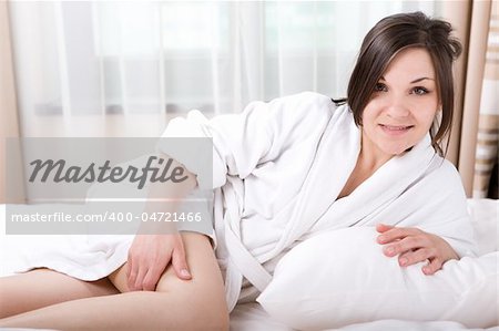 young adult brunette woman in bed