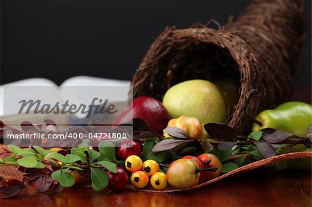 Thanksgiving arrangement with cornucopia and the Bible in background