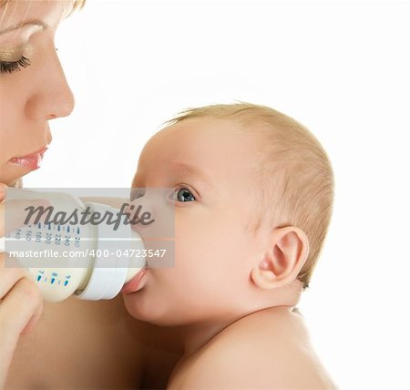 Mother give drink her baby boy by feeding bottle over white