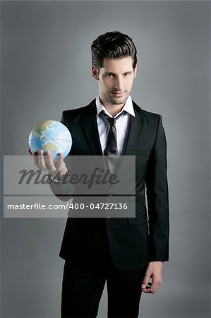 World globe map sphere in businessman hand over dark gray background