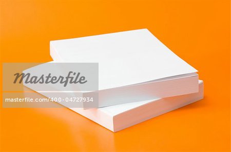 two blank books over an orange background