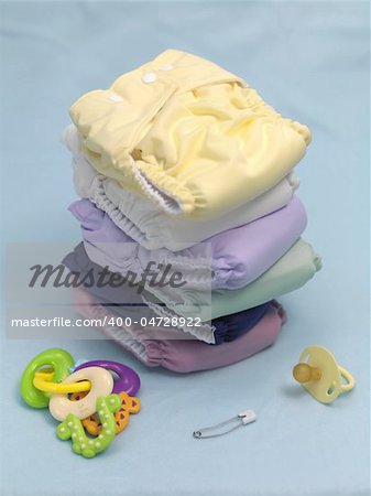 A stack of modern cloth nappies isolated against a blue background