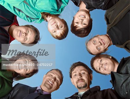 Group of eight people against the sky