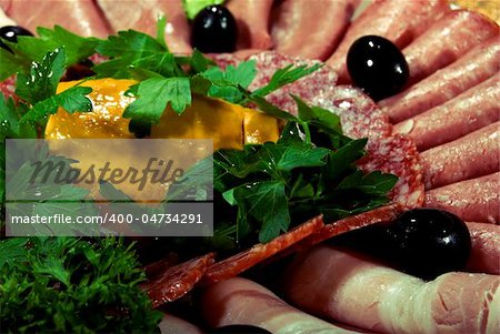 Appetizer made of  meat delicacies and salad