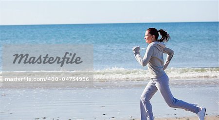 Attractive woman runnng on the beach