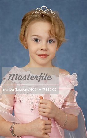 Portrait of a girl - a teenager in a beautiful dress on a blue background