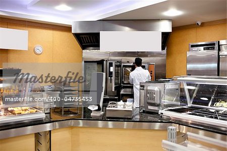 View of a kitchen with baker preparing breads and baguettes in a cafeteria