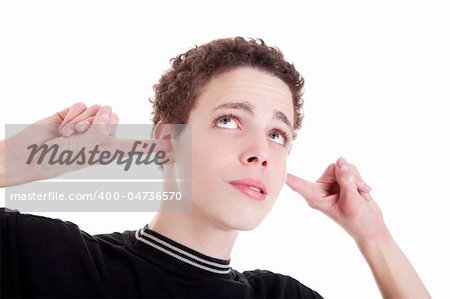 Young man, holding fingers in his ears, bored, not listening, on white, studio shot