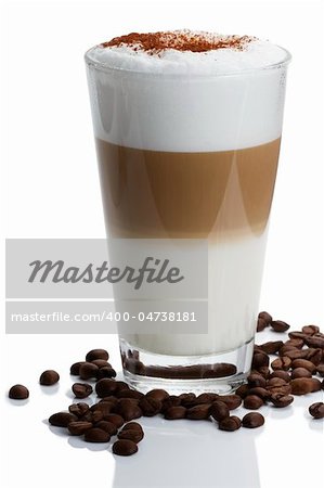 latte macchiato with cocoa powder and coffee beans on white background