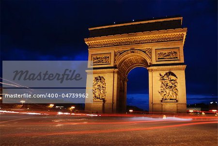 Beautifly lit Triumph Arch at night. Paris, France.