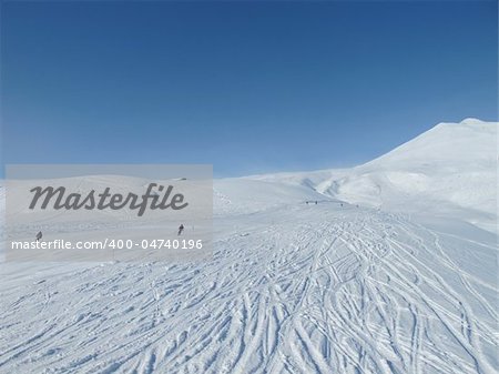 Skiers on wide open piste in French alps. Chamonix.