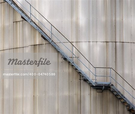 Stairs on the outside of a metal oil silo