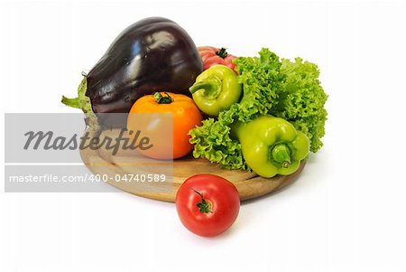 Colorful fresh group of vegetables on a wooden board. White background