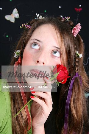 Teenage model with flowers and butterflies in her hair