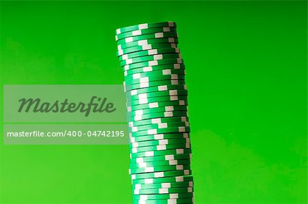 Stack of casino chips against green background