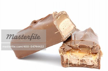 Close up of caramel bar covered in chocolat - cut in half, partially bitten