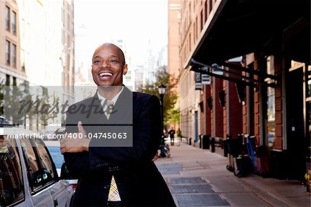 A happy business man, downtown in a city