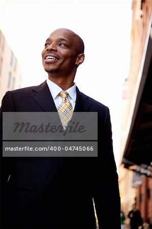 A street portrait of a business man walking on a sidewalk