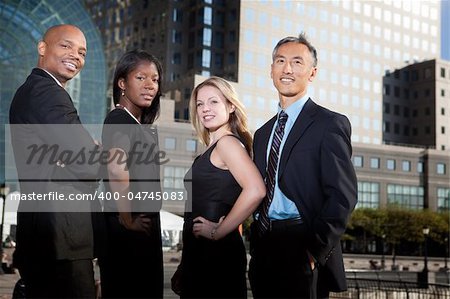 A successful business team in an outdoor setting against a city background