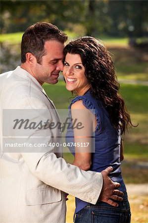 A happy couple in the park having fun on a warm day