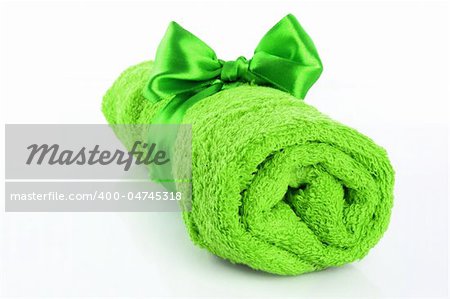 Twisted green towel with band isolated on white
