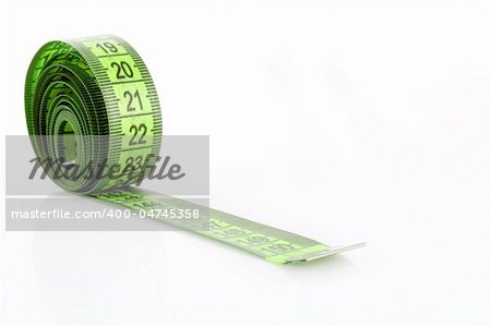 Twisted green measuring  tape isolated on white