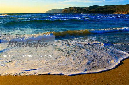 Sand on the Aegean coast and the mountains far away