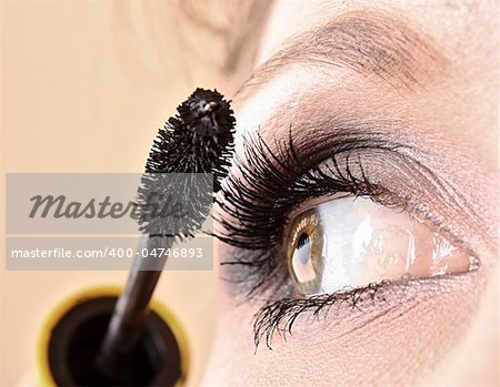 Young woman makeup with mascara eye closeup
