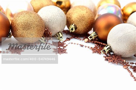 Christmas border with gold and brown ornaments isolated on white background. Shallow dof