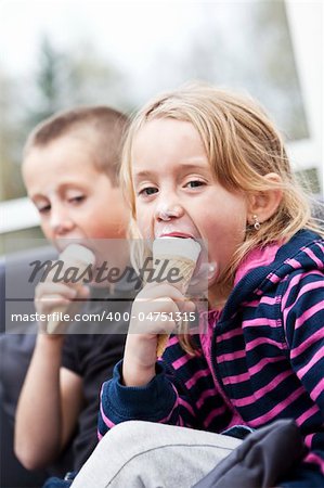 Happy siblings eating ice-cream