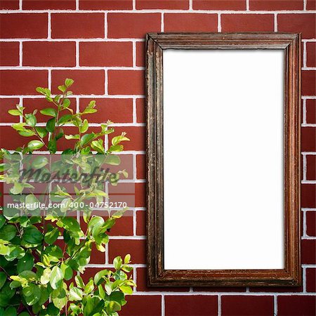 old wood frame on red Brick Wall and little green tree