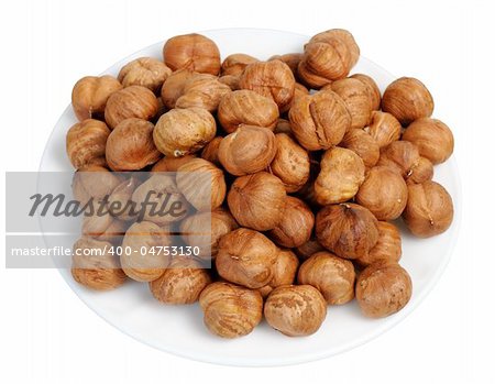 Hazelnuts on a white plate on a white background, isolated.