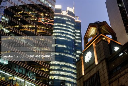 Modern building with skyscraper and tower in night in Hong Kong.