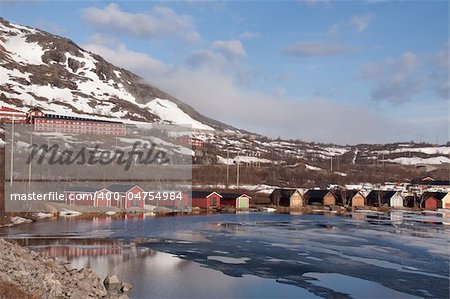 Lakeside cabins with mountain backdrop