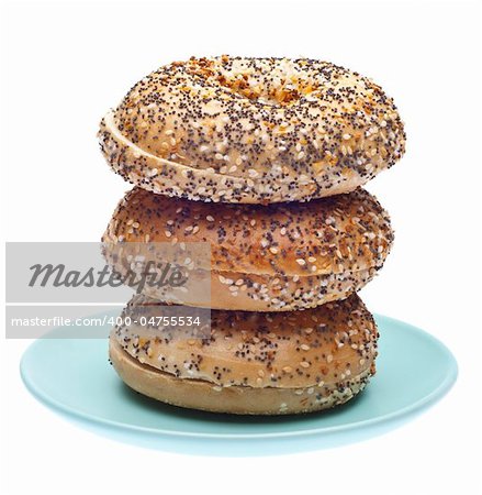 Everything Bagels Stacked on a Blue Plate. Isolated on White with a Clipping Path.