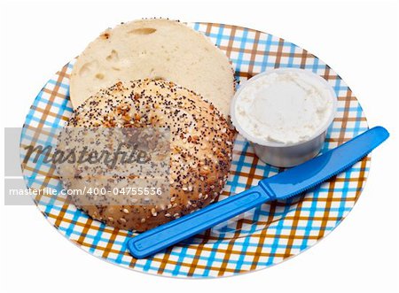 Everything Bagel with Cream Cheese and a Knife on a Plaid Plate. Isolated on White with a Clipping Path.