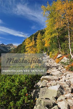 Rocky mountain walkway under blue skies