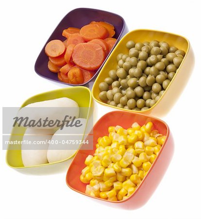Vibrant Canned Vegetables Isolated on White with Clipping Path.  Carrots, Corn, White Potatoes, and Peas.