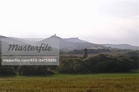 Rural landscape with castle ruins on a distant hill