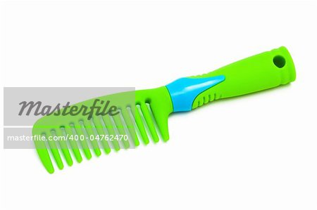 green plastic hairbrush on a white background