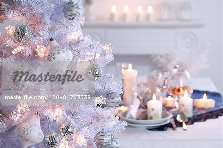 Place setting for Christmas in white with white Christmas tree