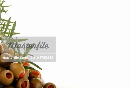 Green olives with red paper and rosmarin isolated on a white background