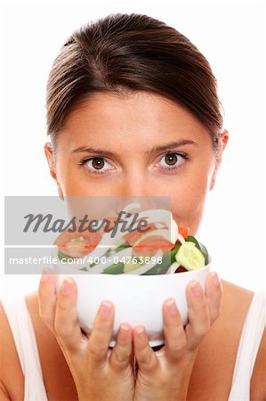 A portrait of a young woman with a bowl of salad over white background