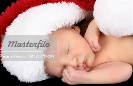 Beautiful Newborn christmas baby wearing a fluffy hat