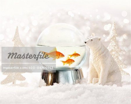 Snow globe with fish in magical winter scene