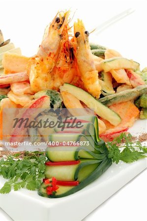 Japanese fried tempura with shrimp and vegetables with parsley garnish.