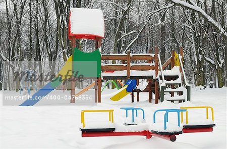A slide in the park covered with snow in winter
