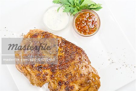 delicious grilled chicken at plate with sauce