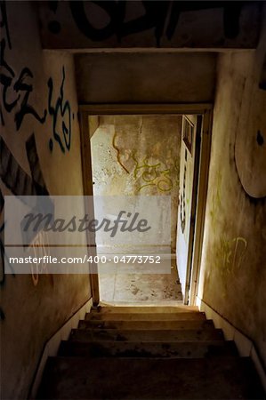 Staircase and exit door of an abandoned house.